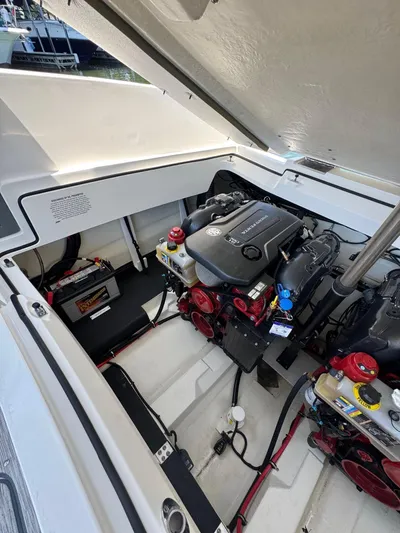  Yacht Photos Pics Engine compartment of a 2022 Cobalt R30 boat, showcasing the engine and battery setup.