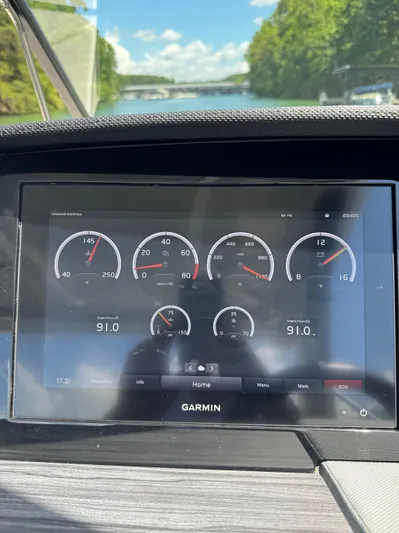  Yacht Photos Pics Garmin display on 2022 Cobalt R30 boat showing engine metrics and scenic waterway view.