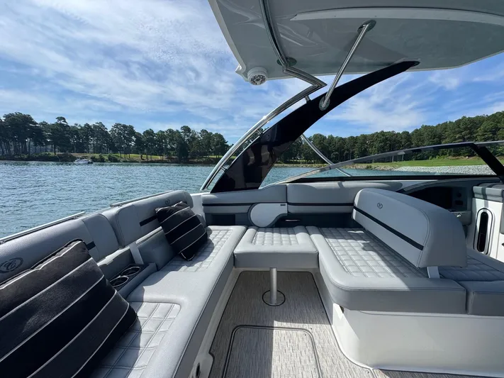  Yacht Photos Pics Luxurious 2022 Cobalt R30 boat interior with plush seating, on a scenic lake.