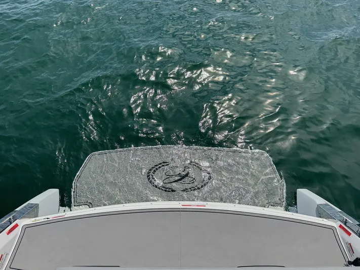  Yacht Photos Pics Rear view of 2022 Cobalt R30 boat on water, showcasing swim platform.