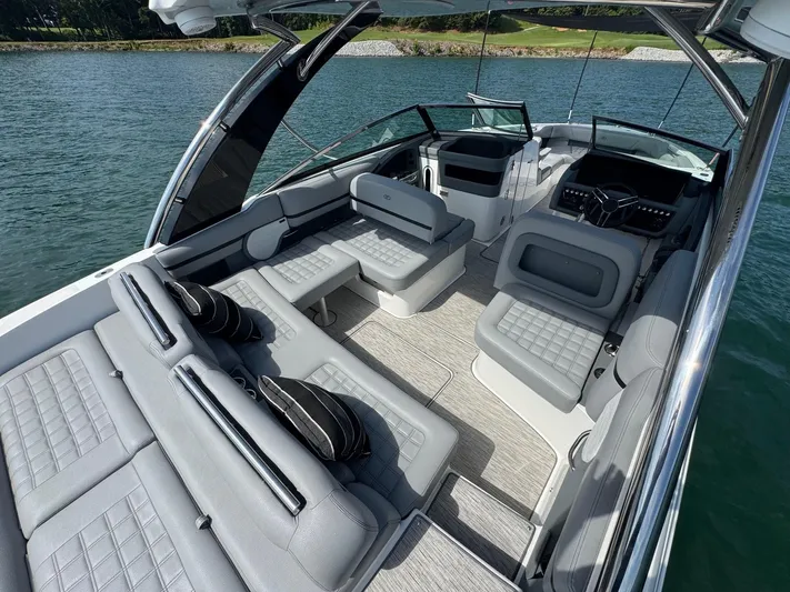  Yacht Photos Pics 2022 Cobalt R30 boat interior with luxurious seating on a serene lake.