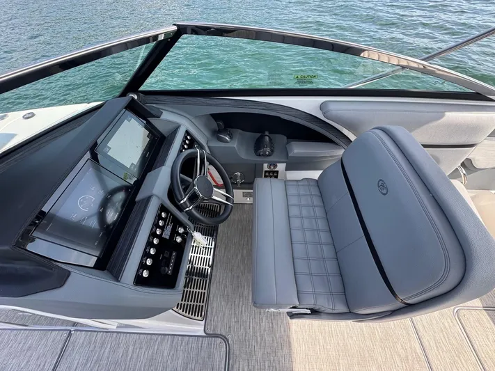  Yacht Photos Pics 2022 Cobalt R30 boat cockpit with modern controls and plush seating on the water.
