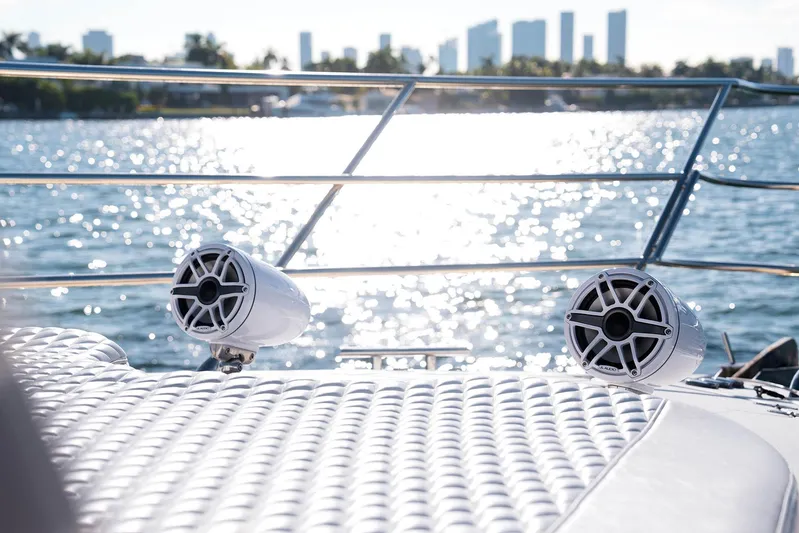  Yacht Photos Pics Azimut 62 Evolution yacht deck with speakers, ocean view, and city skyline in background.
