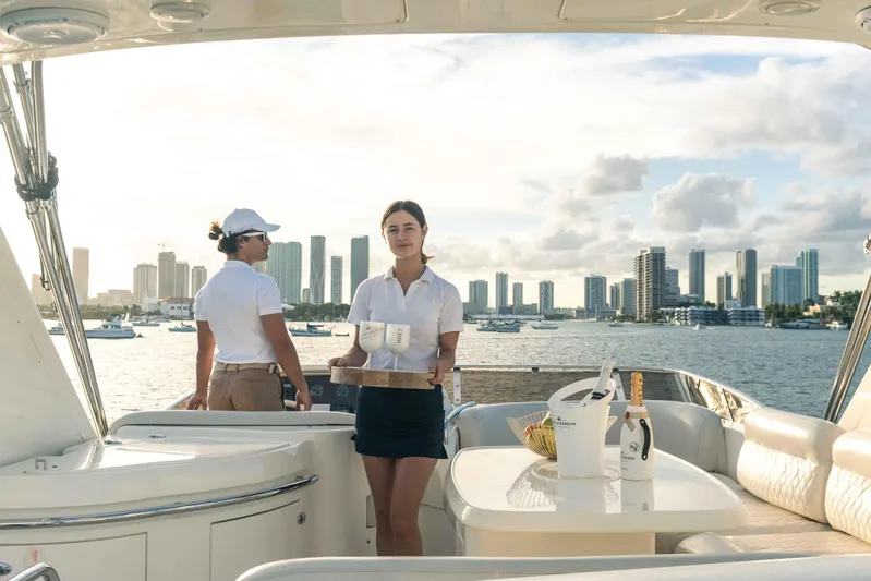  Yacht Photos Pics People on a 2005 Azimut 62 Evolution yacht with city skyline in background.