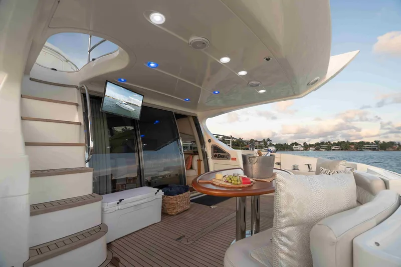  Yacht Photos Pics Luxurious 2005 Azimut 62 Evolution yacht deck with seating, table, and scenic water view.