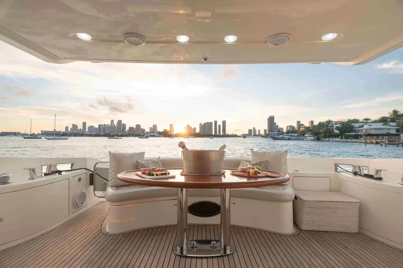  Yacht Photos Pics Luxurious 2005 Azimut 62 Evolution yacht deck with sunset cityscape view.