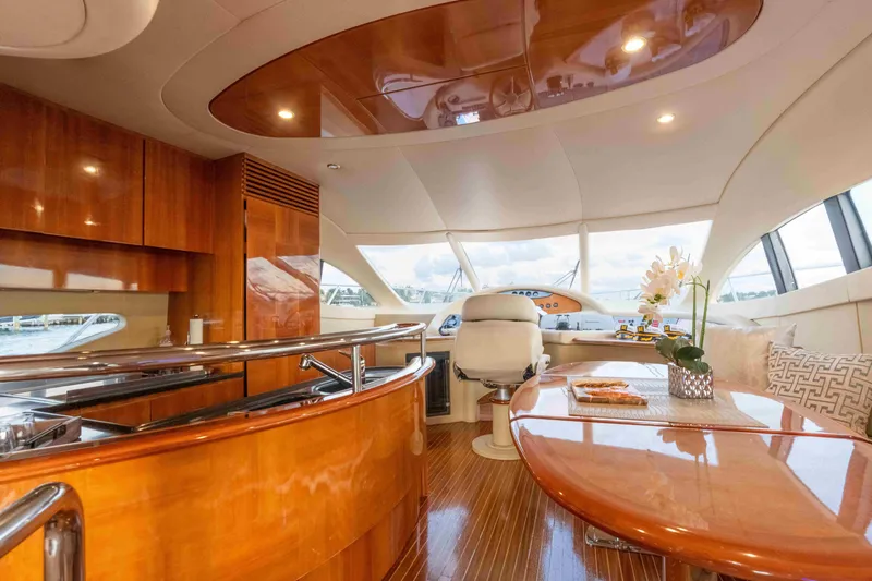 Yacht Photos Pics Luxurious interior of 2005 Azimut 62 Evolution yacht with polished wood finishes.