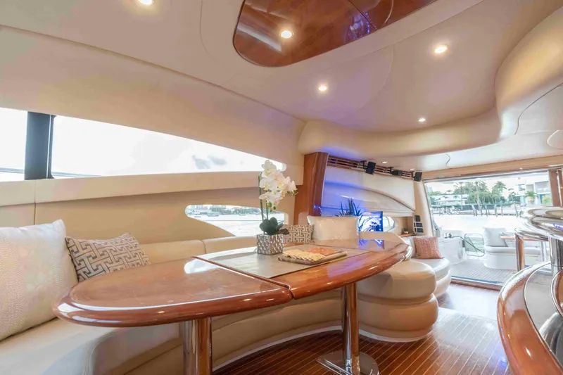  Yacht Photos Pics Luxurious interior of 2005 Azimut 62 Evolution yacht with elegant seating and wooden accents.