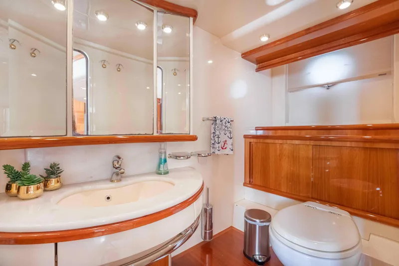  Yacht Photos Pics Luxurious bathroom in 2005 Azimut 62 Evolution yacht with elegant wood accents.
