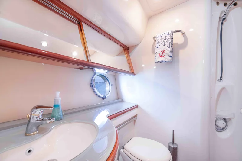  Yacht Photos Pics Luxurious bathroom in 2005 Azimut 62 Evolution yacht, featuring elegant fixtures and nautical decor.