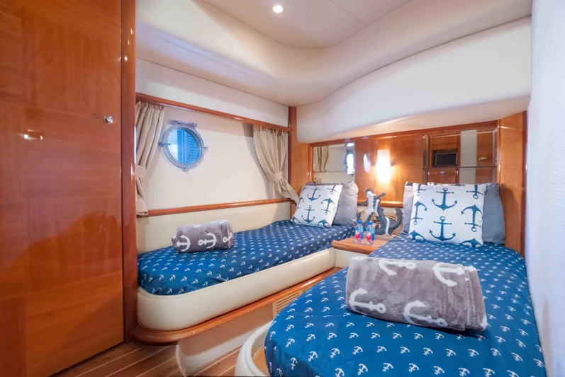  Yacht Photos Pics Luxurious 2005 Azimut 62 Evolution yacht cabin with twin beds and nautical decor.