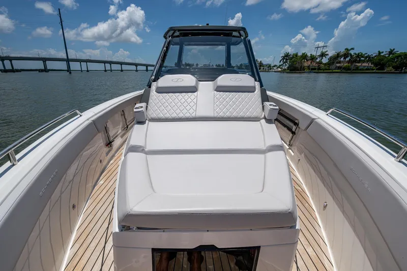 Drei Kinder Yacht Photos Pics 2023 Schaefer V33 boat with luxurious seating, cruising on a sunny day near a bridge.