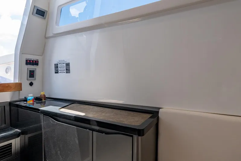 Drei Kinder Yacht Photos Pics Interior of 2023 Schaefer V33 yacht with modern kitchenette and seating area.