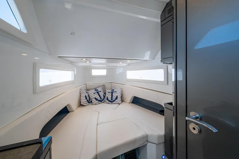 Drei Kinder Yacht Photos Pics Luxurious interior cabin of 2023 Schaefer V33 yacht with plush seating and nautical decor.