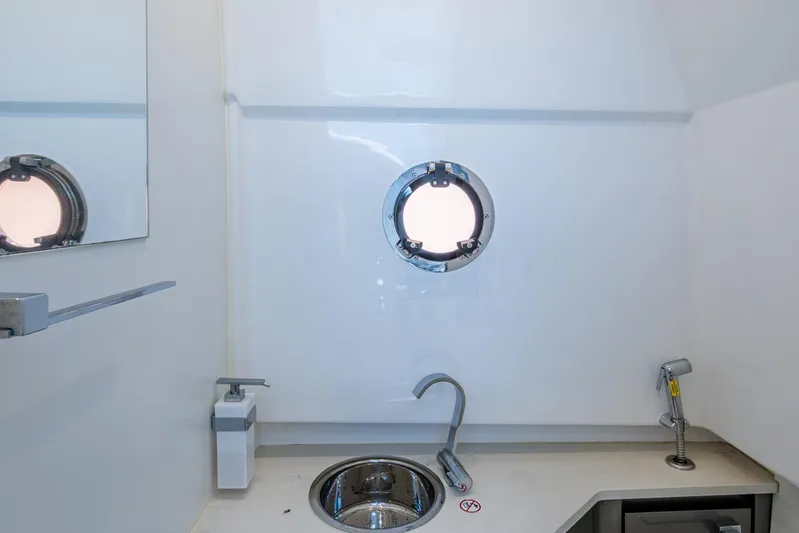 Drei Kinder Yacht Photos Pics 2023 Schaefer V33 yacht interior with porthole, sink, and modern fixtures.
