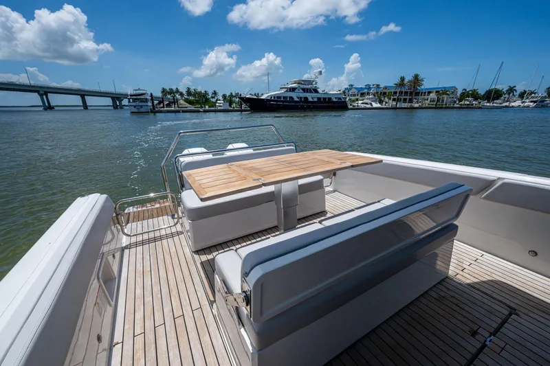Drei Kinder Yacht Photos Pics 2023 Schaefer V33 yacht deck with seating and table, overlooking marina and bridge.