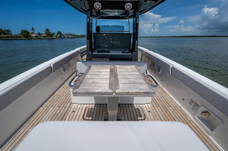 Drei Kinder Yacht Photos Pics 2023 Schaefer V33 boat interior with wooden deck and table on calm water.