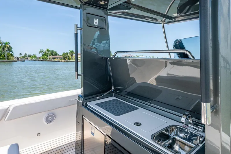 Drei Kinder Yacht Photos Pics 2023 Schaefer V33 yacht with sleek outdoor kitchen and scenic water view.