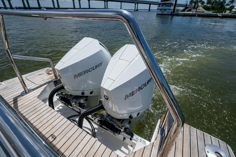 Drei Kinder Yacht Photos Pics 2023 Schaefer V33 boat with dual Mercury outboard engines on a wooden deck.