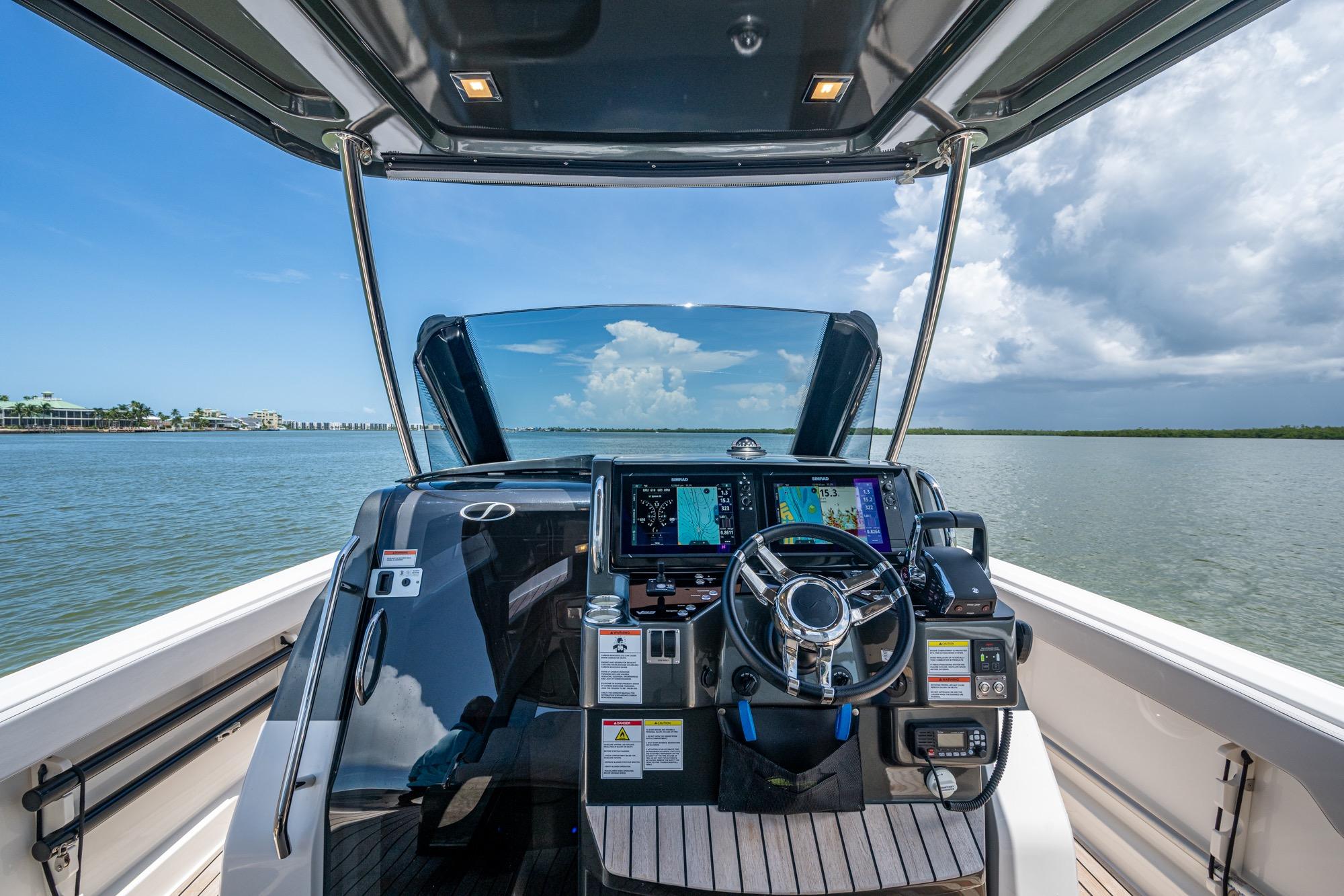 2023 Schaefer V33 boat helm with advanced navigation system on open water.