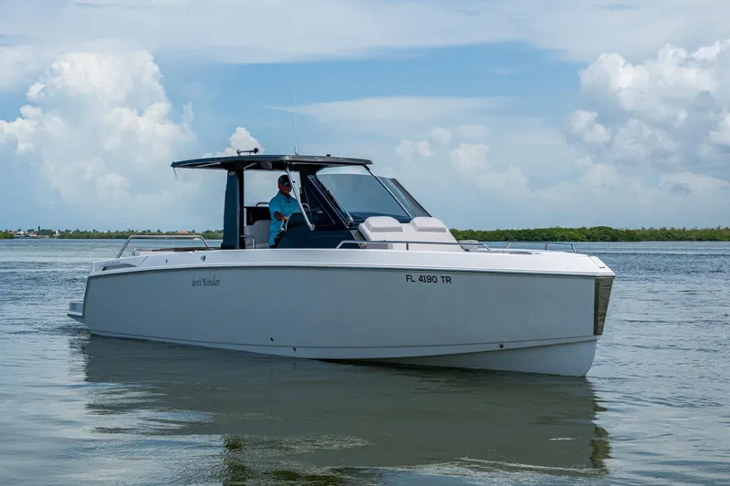 Drei Kinder Yacht Photos Pics 2023 Schaefer V33 boat cruising on calm waters under a cloudy sky.