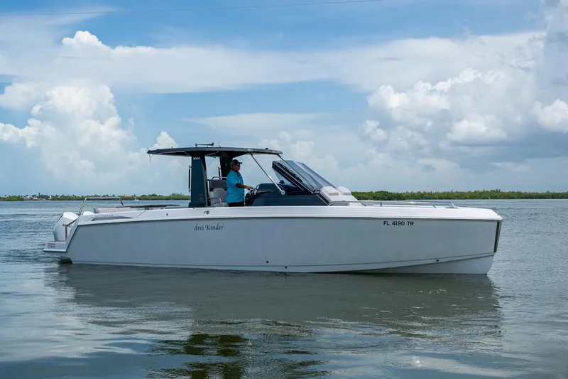 Drei Kinder Yacht Photos Pics 2023 Schaefer V33 boat cruising on calm waters under a partly cloudy sky.