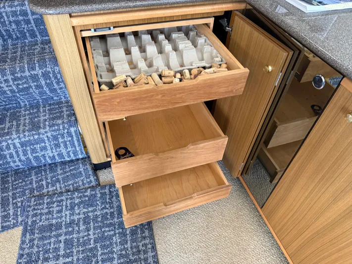 The Office Yacht Photos Pics Open wooden drawers with wine corks in a Bayliner 5288 Pilot House Motoryacht, 2001.