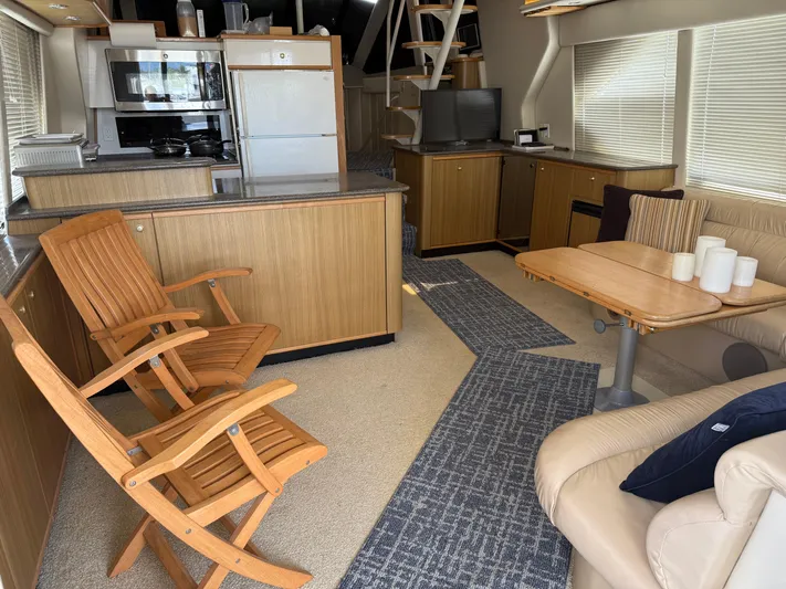 The Office Yacht Photos Pics Interior of 2001 Bayliner 5288 Pilot House Motoryacht with wooden furniture and modern amenities.