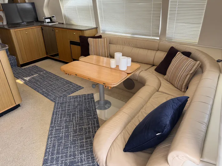The Office Yacht Photos Pics Luxurious interior of 2001 Bayliner 5288 Pilot House Motoryacht with cozy seating and elegant decor.