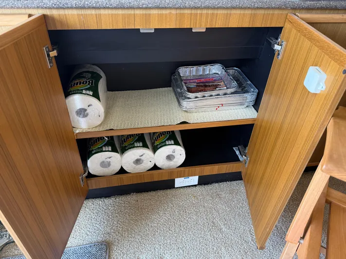 The Office Yacht Photos Pics Open cabinet in 2001 Bayliner 5288 yacht with paper towels and foil trays.