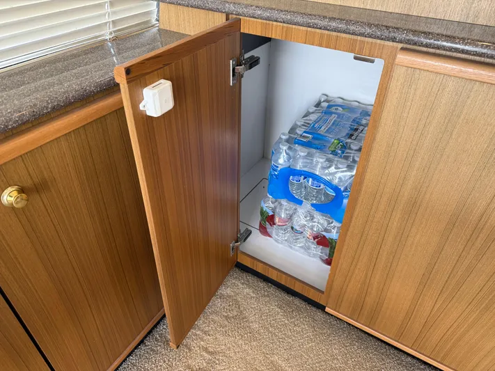 The Office Yacht Photos Pics Cabinet on 2001 Bayliner 5288 yacht, storing bottled water packs.