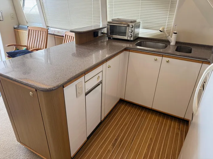 The Office Yacht Photos Pics 2001 Bayliner 5288 Pilot House Motoryacht kitchen with modern appliances and sleek countertops.