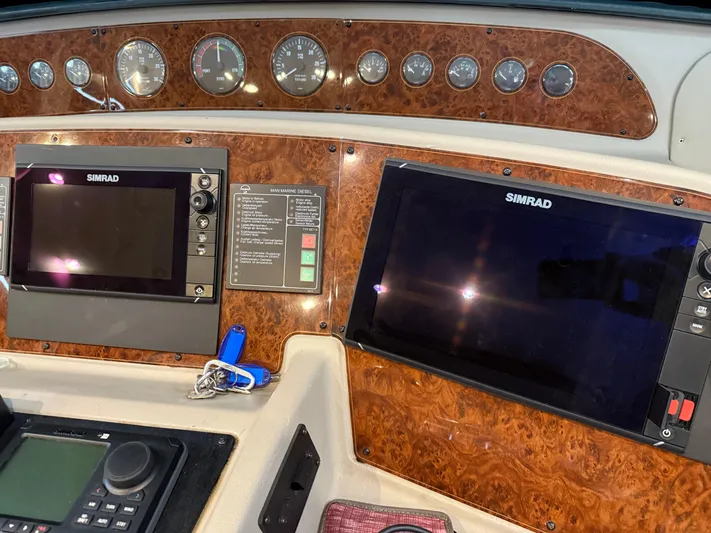 The Office Yacht Photos Pics Dashboard of 2001 Bayliner 5288 Pilot House Motoryacht with Simrad navigation displays.