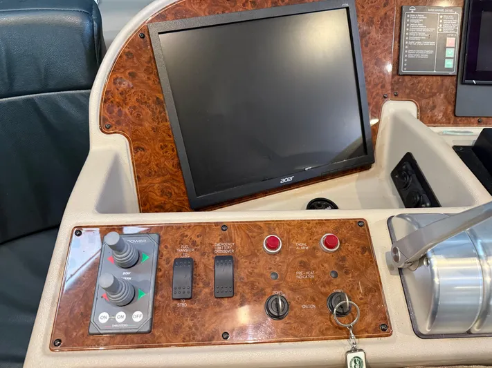The Office Yacht Photos Pics Control panel of 2001 Bayliner 5288 Pilot House Motoryacht with screen and switches.