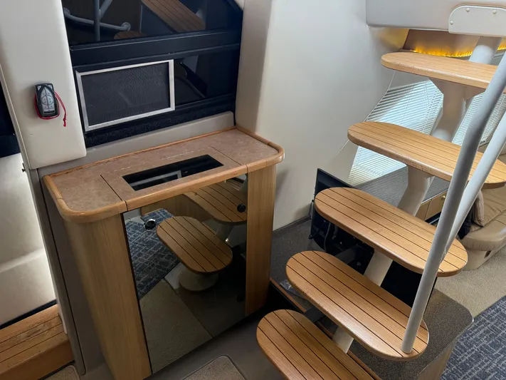 The Office Yacht Photos Pics Interior of 2001 Bayliner 5288 Pilot House Motoryacht with wooden stairs and cabinet.