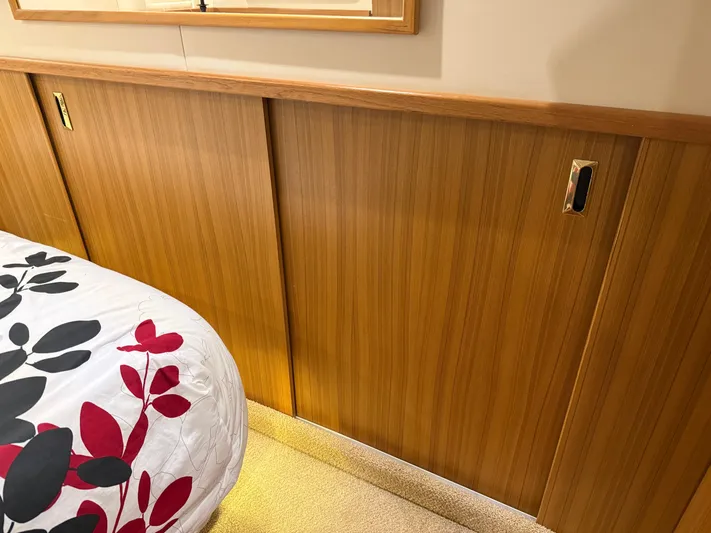 The Office Yacht Photos Pics Wood-paneled interior of 2001 Bayliner 5288 Pilot House Motoryacht with floral bedding.