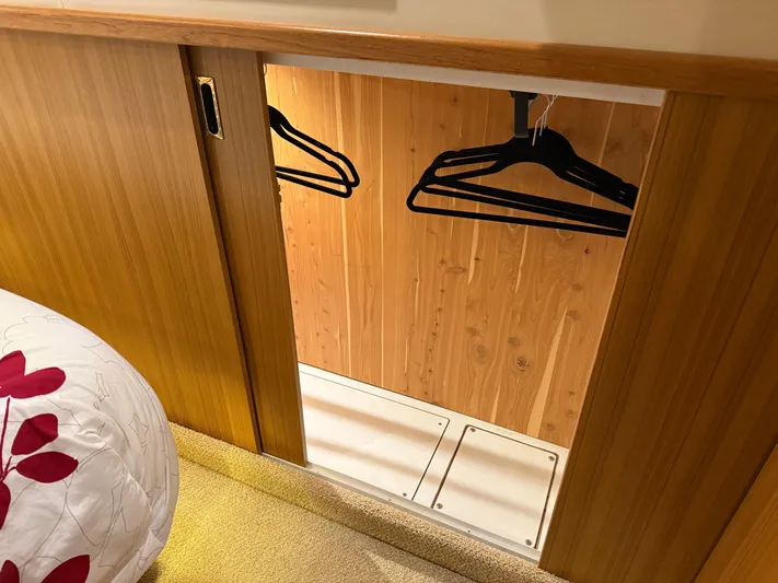 The Office Yacht Photos Pics Wooden closet with hangers in 2001 Bayliner 5288 Pilot House Motoryacht interior.