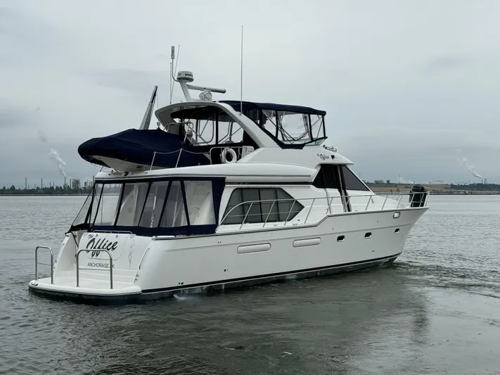 The Office Yacht Photos Pics 2001 Bayliner 5288 Pilot House Motoryacht cruising on a calm waterway.