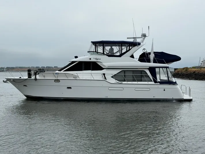 The Office Yacht Photos Pics 2001 Bayliner 5288 Pilot House Motoryacht on calm water, side view.