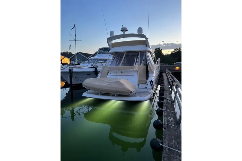  Yacht Photos Pics 2012 Sunseeker Manhattan 53 yacht docked at sunset with underwater lights.