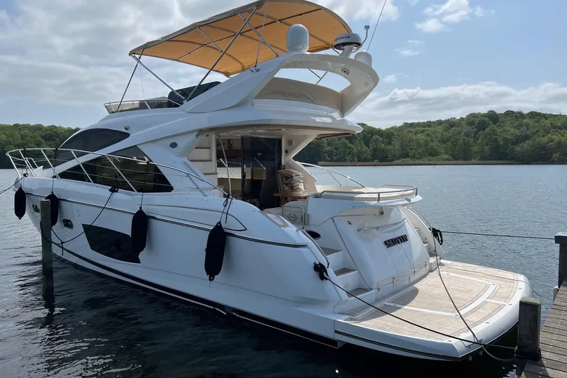  Yacht Photos Pics Luxurious 2012 Sunseeker Manhattan 53 yacht docked on serene water.