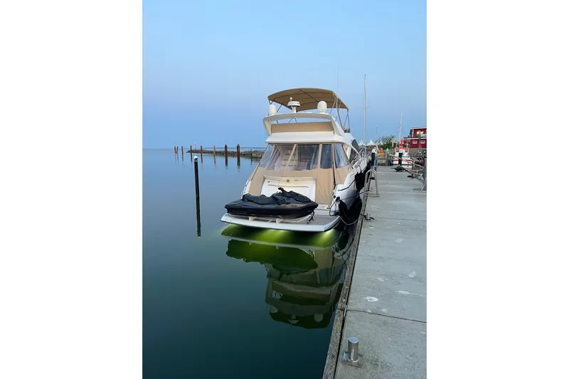  Yacht Photos Pics 2012 Sunseeker Manhattan 53 yacht docked at a serene marina.