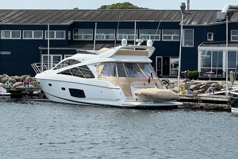  Yacht Photos Pics 2012 Sunseeker Manhattan 53 yacht docked at marina, modern design, white exterior.