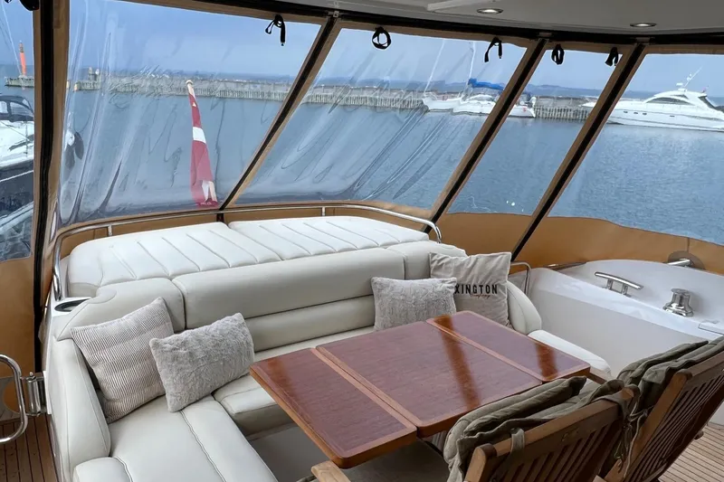  Yacht Photos Pics Luxurious 2012 Sunseeker Manhattan 53 yacht interior with plush seating and scenic marina view.