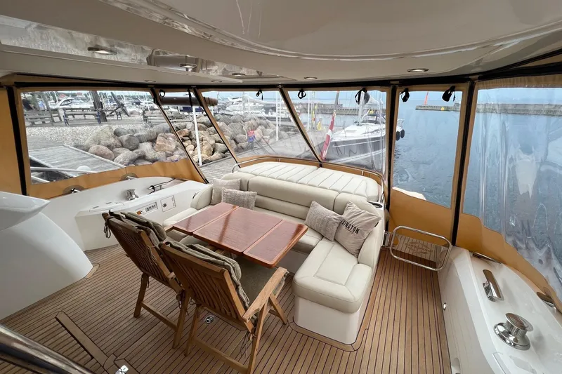  Yacht Photos Pics Luxurious 2012 Sunseeker Manhattan 53 yacht interior with elegant seating and wooden table.