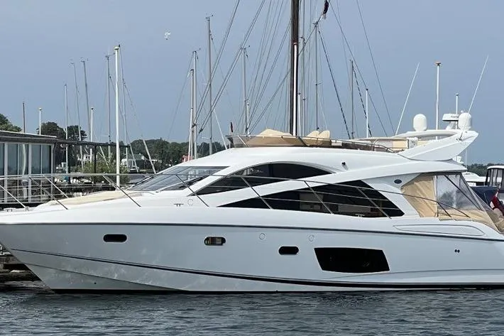  Yacht Photos Pics 2012 Sunseeker Manhattan 53 yacht docked at marina, sleek white design.