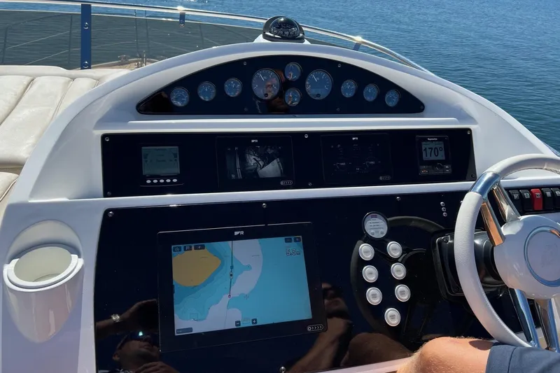  Yacht Photos Pics Cockpit of 2012 Sunseeker Manhattan 53 yacht with navigation controls and sea view.
