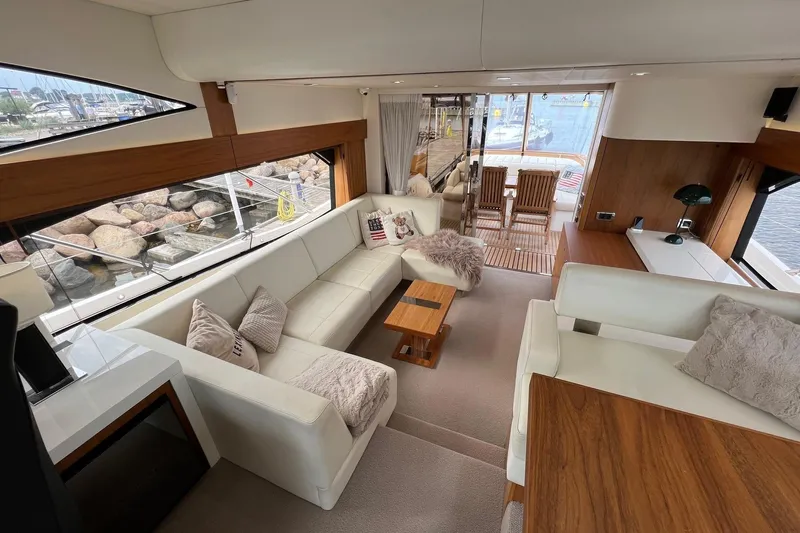  Yacht Photos Pics Luxurious interior of 2012 Sunseeker Manhattan 53 yacht with elegant seating and wooden accents.