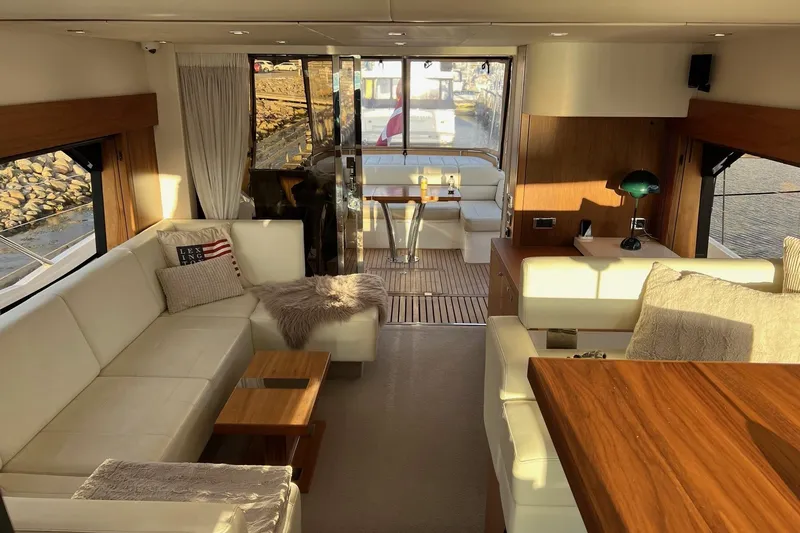  Yacht Photos Pics Luxurious interior of 2012 Sunseeker Manhattan 53 yacht with elegant seating and wooden accents.