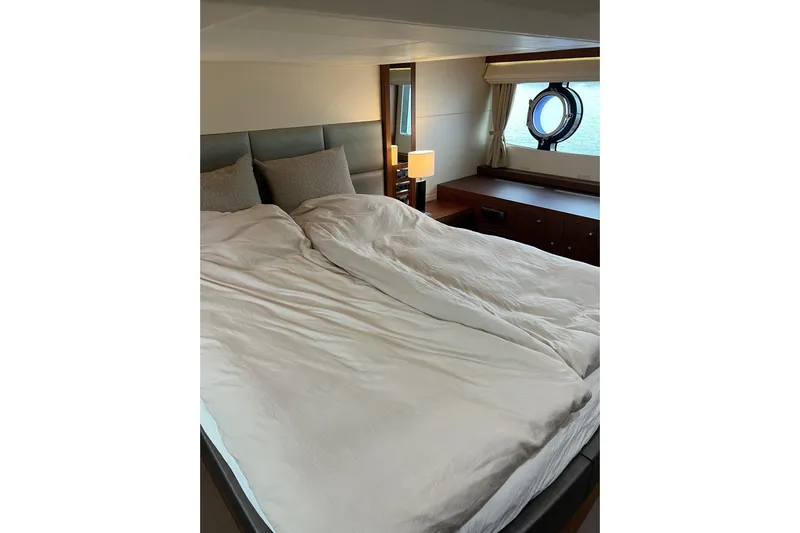  Yacht Photos Pics Luxurious bedroom interior of 2012 Sunseeker Manhattan 53 yacht with porthole view.